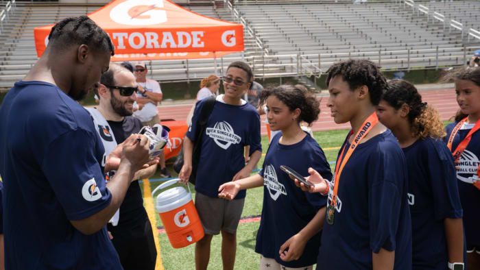 Penn State running back Nicholas Singleton signs autographs at the Nick Singleton Football Camp at Governor Mifflin High School.